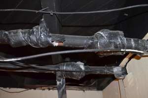 Old asbestos insulation wrapped with duct tape.